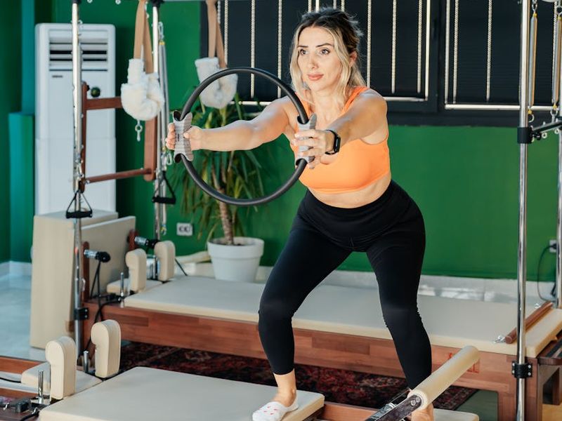 Woman performs a core strengthening exercise on a mat.